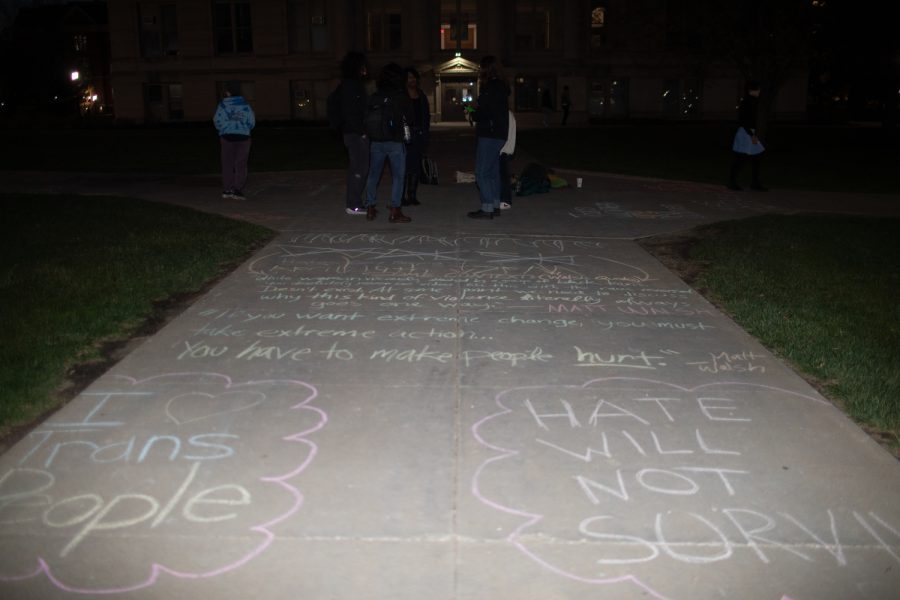 University+of+Iowa+students+write+with+chalk+on+the+Pentacrest+in+support+of+the+transgender+community+on+Monday+evening%2C+April+17%2C+2023.+The+event+took+place+two+days+before+political+commentator+Matt+Walsh+is+set+to+arrive+to+Iowa%E2%80%99s+campus.+