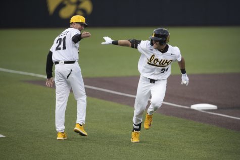 Iowa first basemen Brennen Dorighi high-fives head coach Rick Heller after hitting a home run during a baseball game between Iowa and Bradley at Duane Banks Field on Wednesday, April 19, 2023.The Iowa Hawkeyes defeated the Bradley Braves, 6-1. Dorighi recorded two hits in five at-bats.