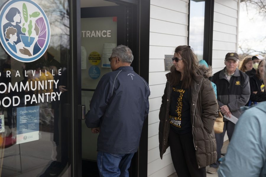 Community members walk into the Coralville Community Food Pantry for Caitlin Clark’s charity event on Friday, April 21, 2023.
