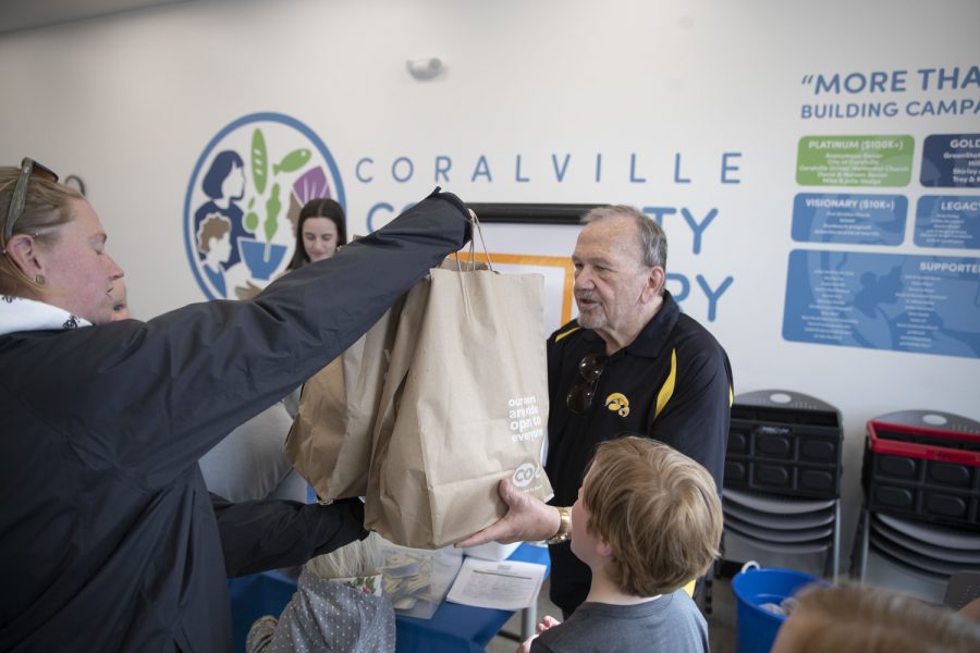 A Community member hands over a donation during Caitlin Clark’s charity event at the Coralville food pantry on Friday, April 21, 2023.