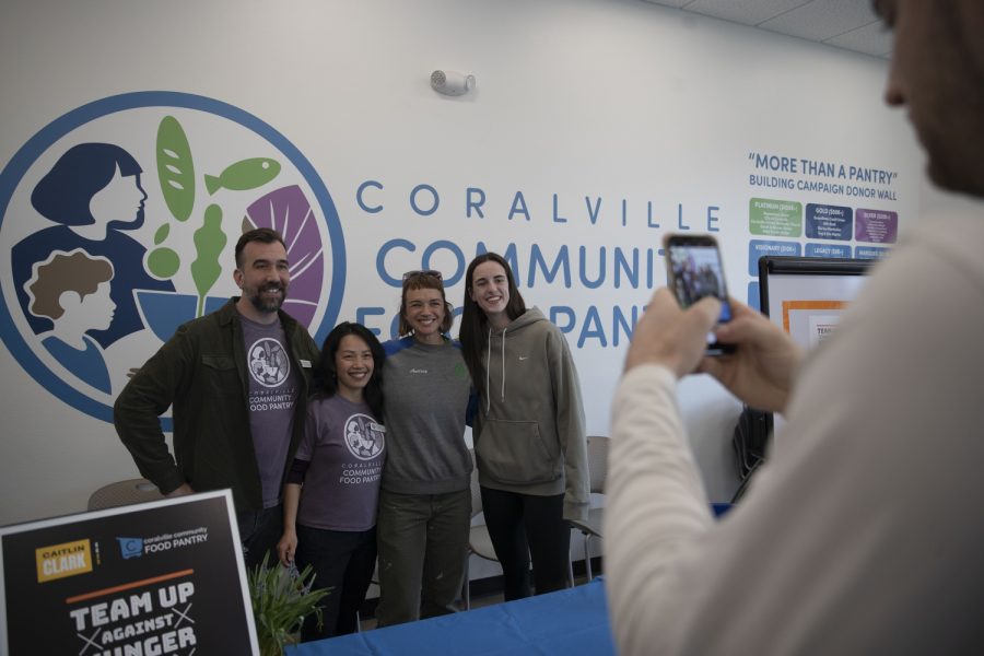 Iowa+guard+Caitlin+Clark+takes+a+photo+with+Coralville+Community+food+Pantry+workers+during+a+charity+event+at+the+Coralville+food+pantry+on+Friday%2C+April+21%2C+2023.