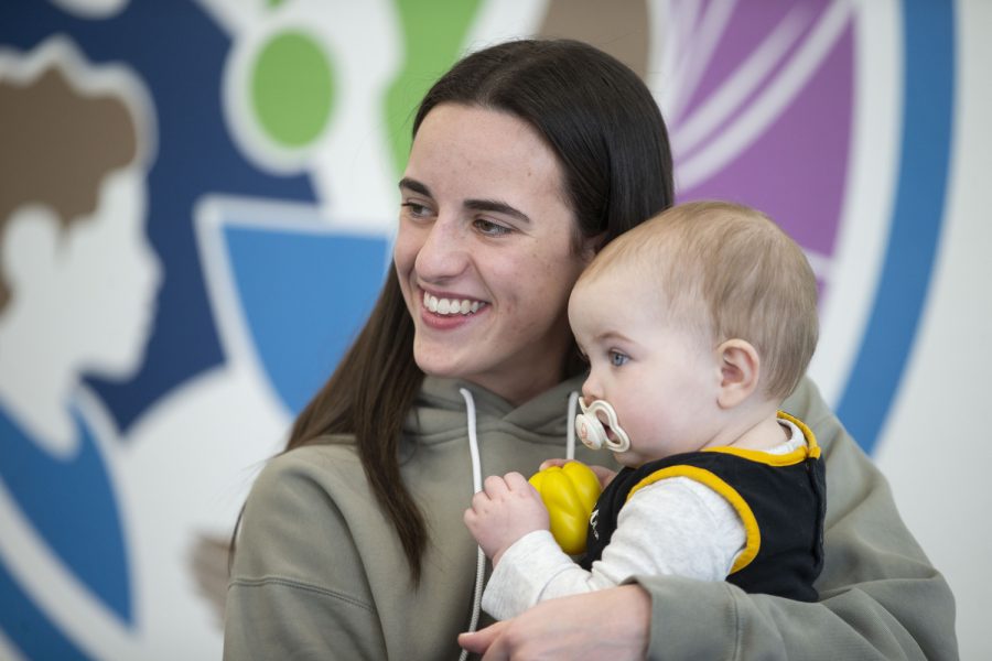 Iowa guard Caitlin Clark poses for a photo with 1-year old Ivy during a charity event at the Coralville food pantry on Friday, April 21, 2023.