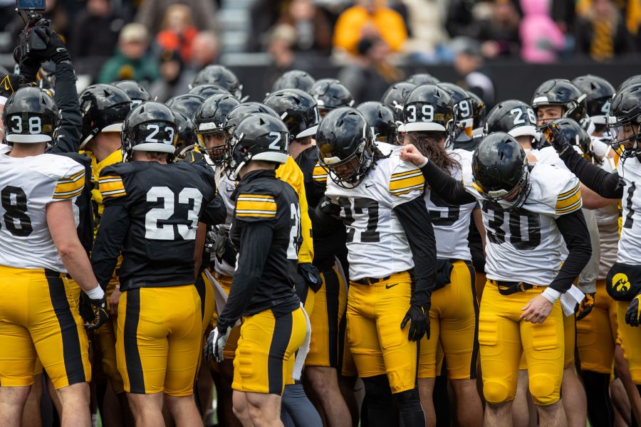 Iowa’s football team huddles during a spring football practice at the Kinnick Stadium on Saturday, April 22, 2023.