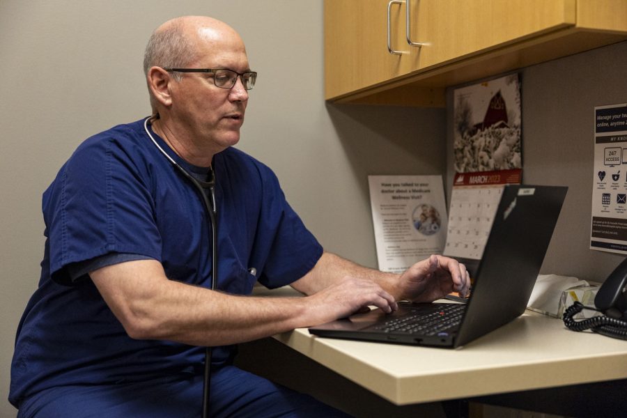 Dr. Brent Hoehns types on a computer at the Knoxville Hospital and Clinics in Knoxville, Iowa on Tuesday, March 14, 2023. Hoehns has been a doctor for 28 years and sees the benefits of working in a smaller hospital. It’s big enough that you can have eight or 10 partners, but small enough that you get to know the administration. You get a lot more say in how things are run than if you’re one of a thousand physicians in a system,” Hoehns said. 