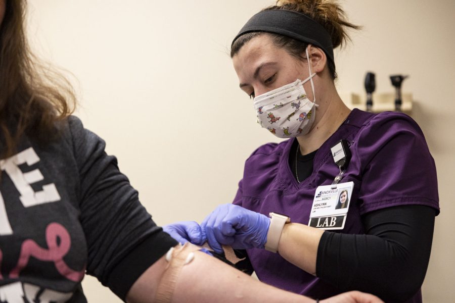 Phlebotomist Ashlynn Woollums draws Andrea Mathes’ blood at the Knoxville Hospital and Clinics in Knoxville, Iowa on March 14, 2023. 