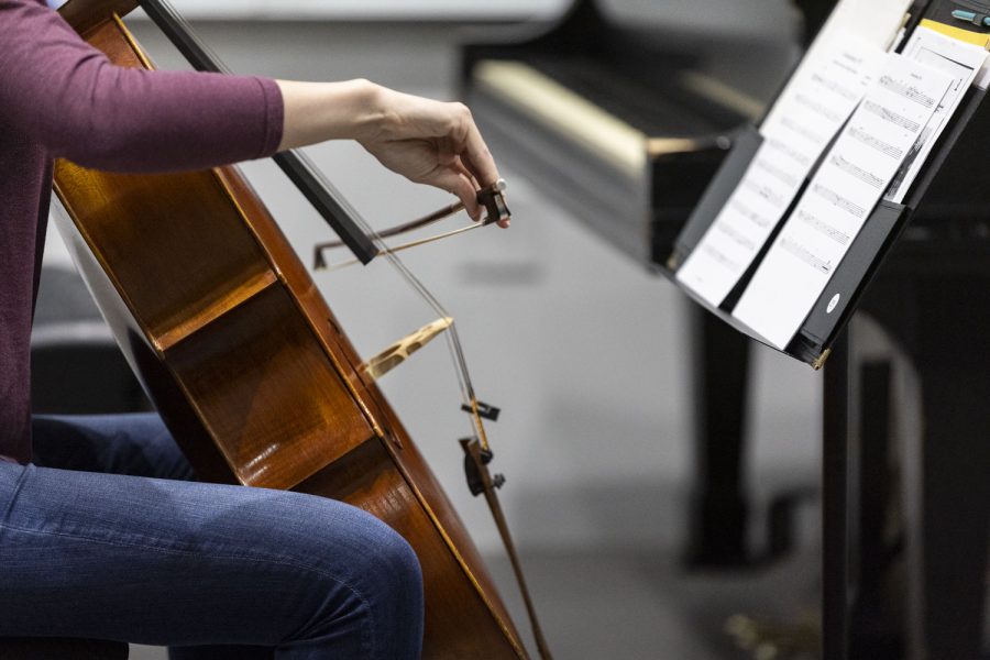 Natalie Krzeski plays the cello during a dress rehearsal of the opera “The Great Flood” at the Voxman Music Building on Monday, April 24, 2023. Nathan Felix is the composer of the opera and it will premiere Thursday, April 27.