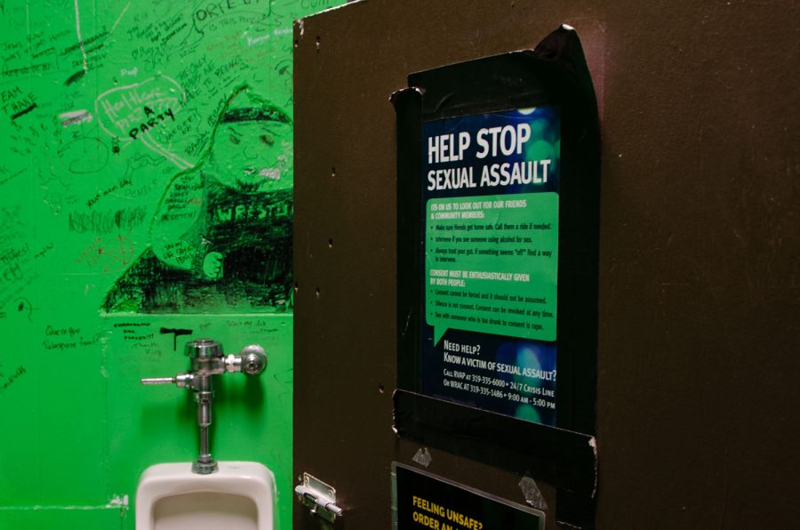 A poster is seen on the outside of a bathroom stall door in Deadwood, a bar in Iowa City, on April 8, 2023. 