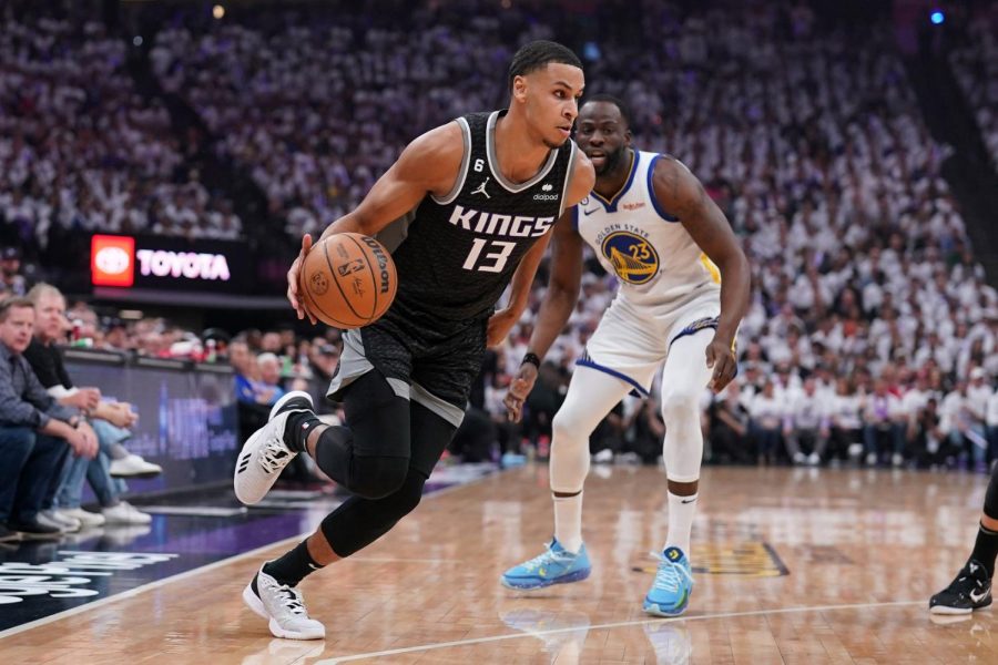 Apr 15, 2023; Sacramento, California, USA; Sacramento Kings forward Keegan Murray (13) dribbles past Golden State Warriors forward Draymond Green (23) in the first quarter during game one of the 2023 NBA playoffs at the Golden 1 Center.