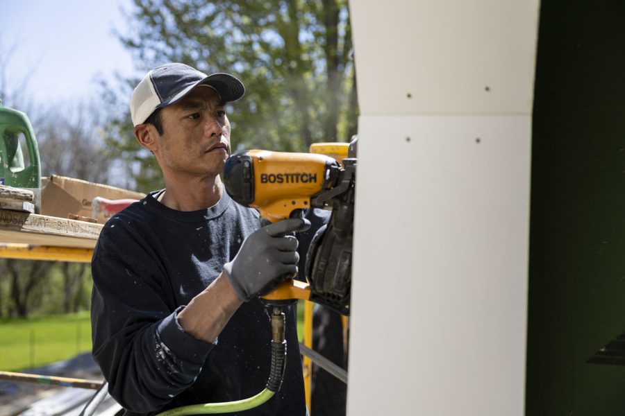 Meticulous Masonry employee Cho Kantaphone uses a nail gun at a construction site in Iowa City on Monday, May 1, 2023. Meticulous Masonry has worked with Martin Construction for 13 years. 