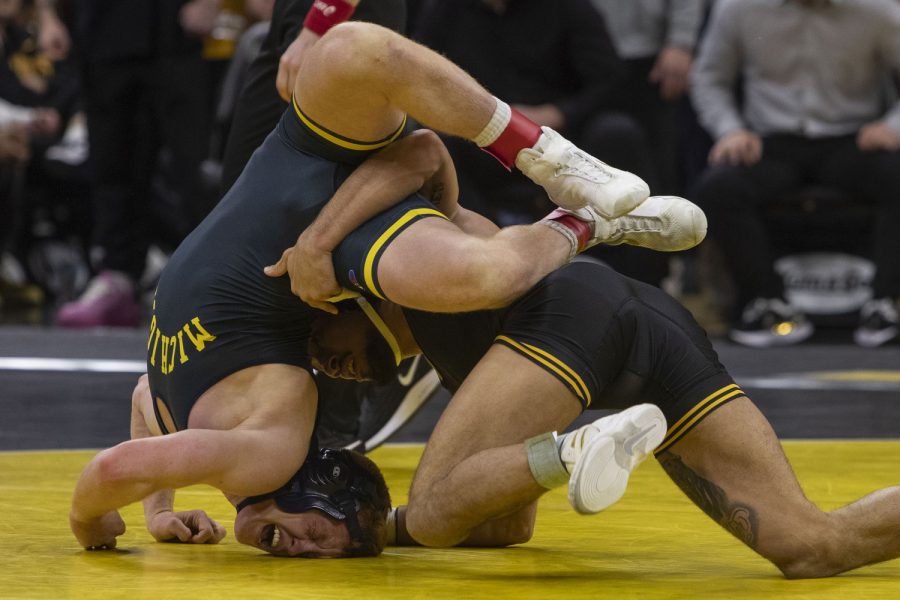 Iowa’s No.2 141-pound Real Woods wrestles Michigan’s Pat Nolan during a wrestling dual between No. 2 Iowa and No. 9 Michigan at Carver-Hawkeye Arena on Friday, Feb. 10, 2023. The Hawkeyes defeated the Wolverines 33-8. Woods defeated Nolan 15-1.
