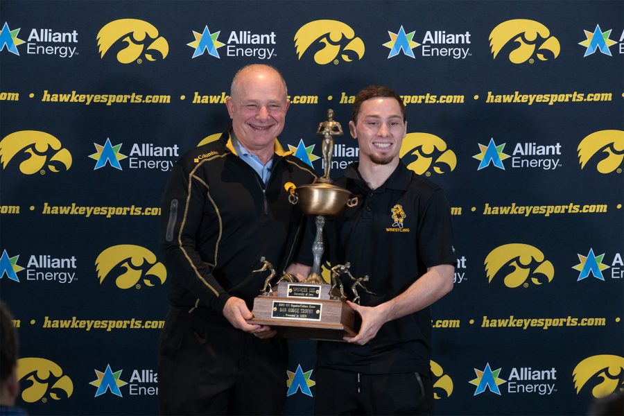 Iowa wrestler Spencer Lee holds the Hodge Trophy with his father, Larry at Kinnick Stadium on January 5 2021. The Hodge Trophy is awarded to the best wrestler in the nation and Lee is one of three Hawkeyes to win the award.