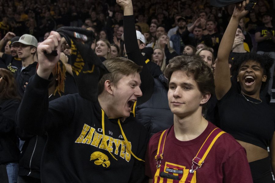 An Iowa fan yells in an Iowa State fan’s ear during a basketball game Iowa and Iowa State at Carver-Hawkeye Arena in Iowa City on Dec. 8, 2022. The Hawkeyes defeated the Cyclones, 75-56.