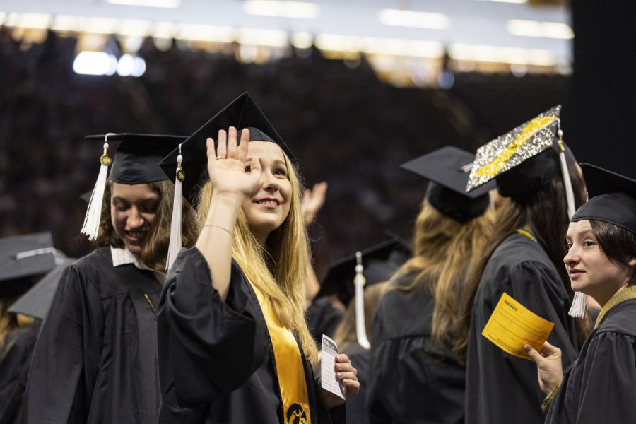A graduate waves to the crowd during the University of Iowas spring 2023 Commencement Ceremony for the College of Liberal Arts and Sciences at Carver-Hawkeye Arena on Saturday, May 13, 2023. The ceremony marks one of two Liberal Arts and Sciences ceremonies.