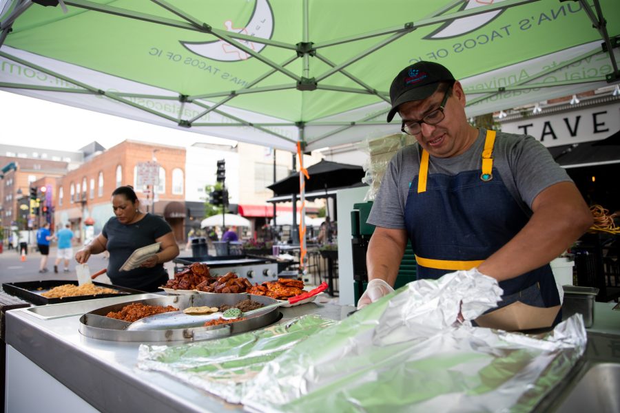 Luna’s Tacos cooks and founders Mr. and Mrs. Garcia prepare food in downtown Iowa City during day one of the 2023 Summer of the Arts Festival on Friday, June 2.