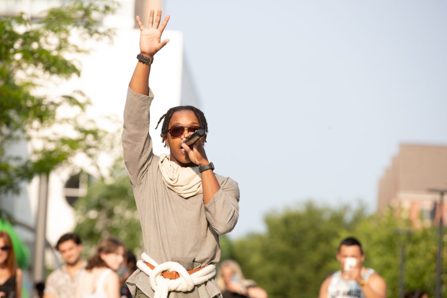 Local hip-hop artist TheZeffster performs during a fashion show at the 2023 Juneteenth Celebration in downtown Iowa City on Friday, June 16.
