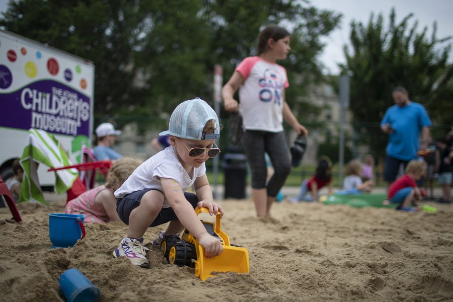 William Pretorius plays in the sand during the 6th annual Downtown Iowa City Block Party on Saturday, June 24, 2023. 