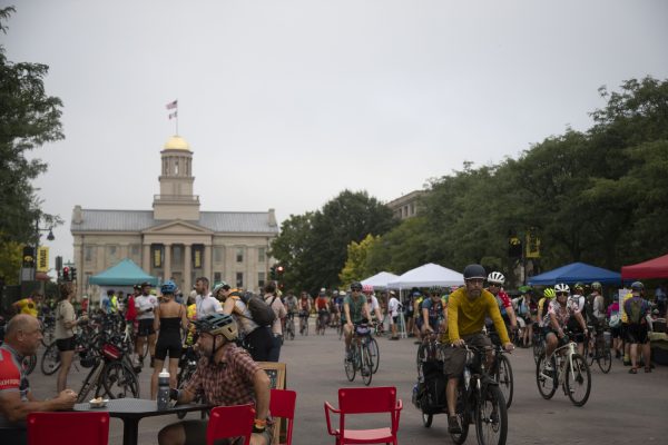 A hectic scene is seen on the streets of Iowa City on July 29, 2023. Bikers eat breakfast while some head out on the 66 mile ride to Davenport