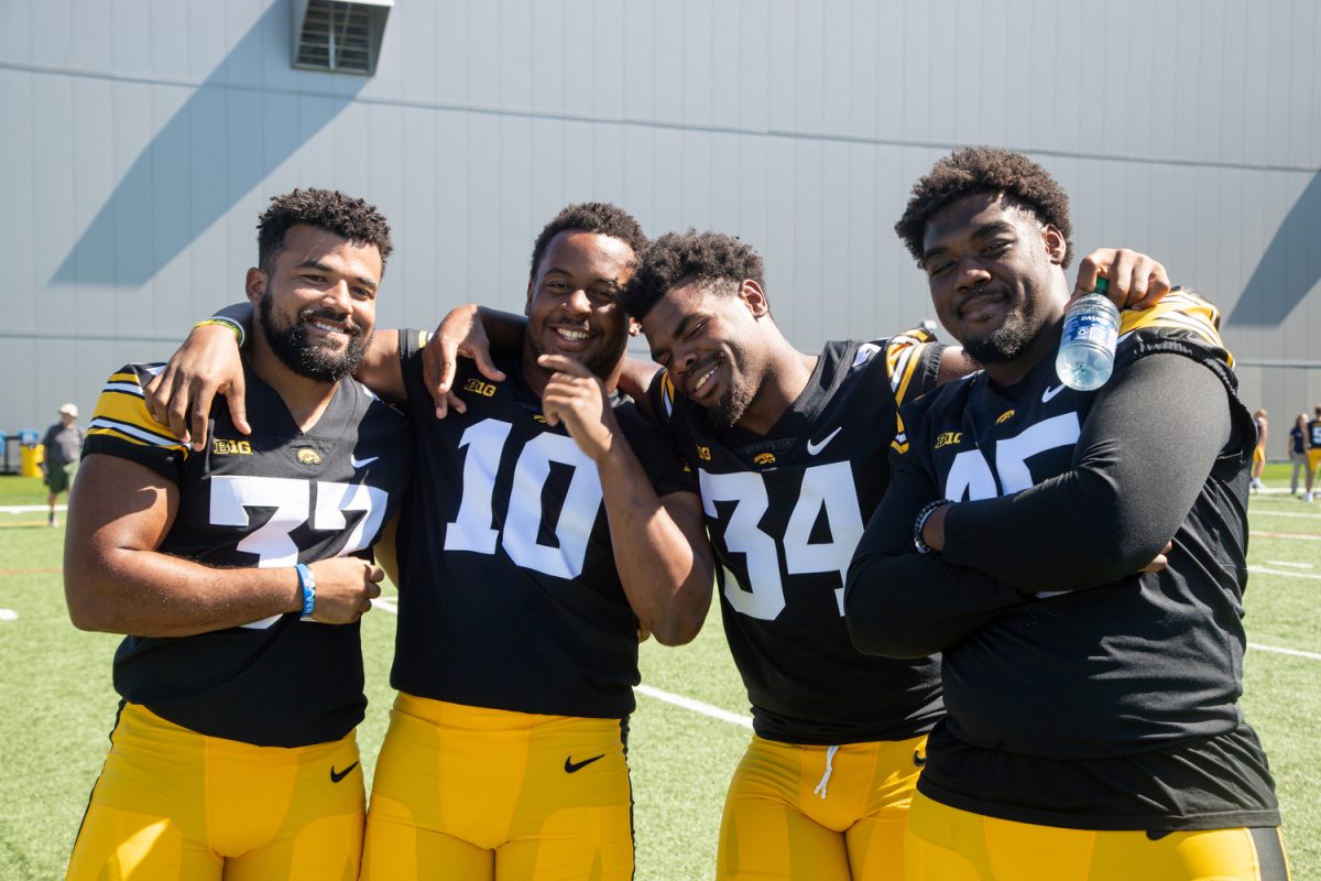 Iowa linebackers Kyler Fisher, Nick Jackson, Jay Higgins, and defensive lineman Deontae Craig pose for a portrait during Iowa football media day in Iowa City on Friday, Aug. 11, 2023.