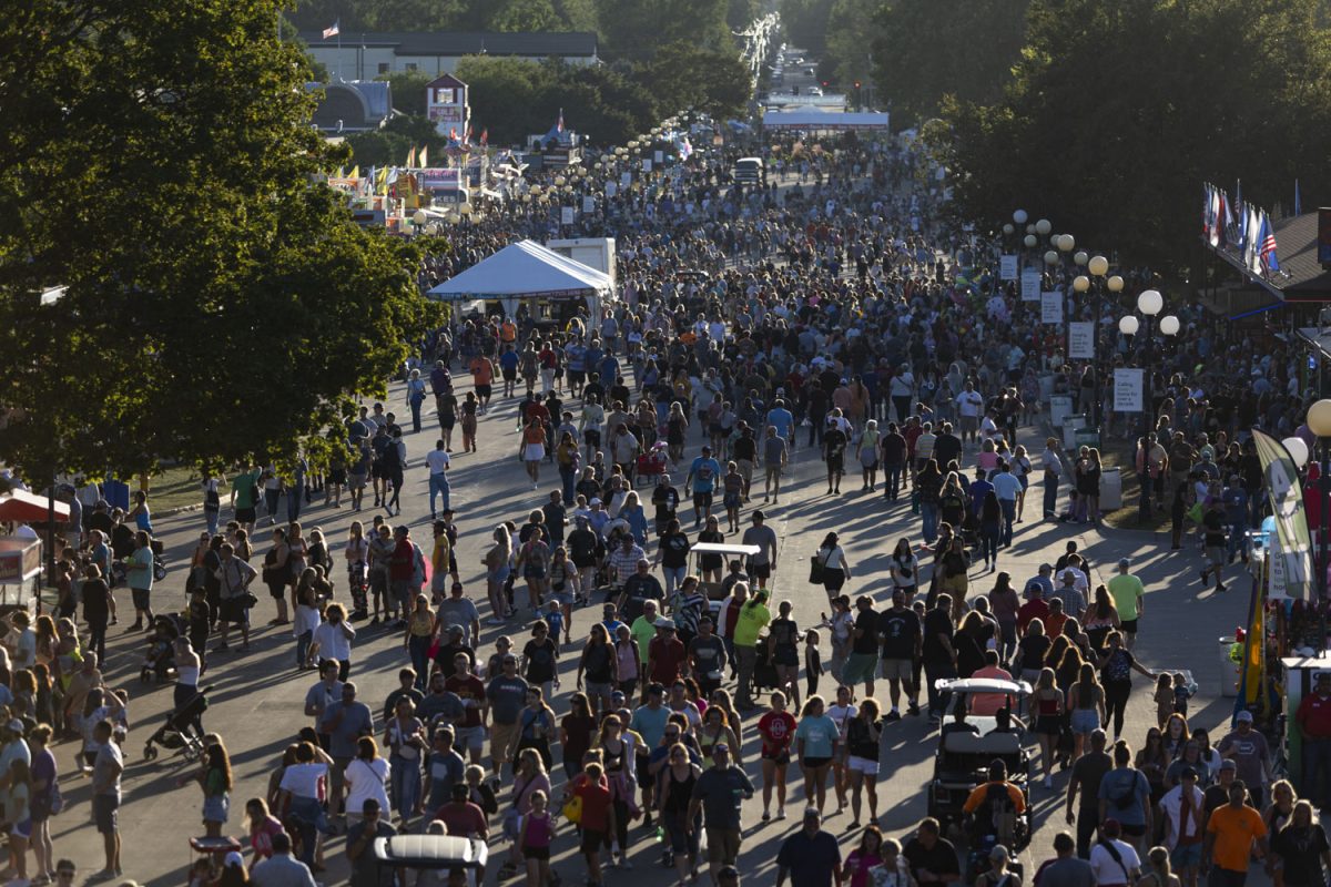 Fairgoers walk down Grand Avenue during the Iowa State Fair at the Iowa State Fairgrounds in Des Moines on Tuesday, Aug. 15, 2023.