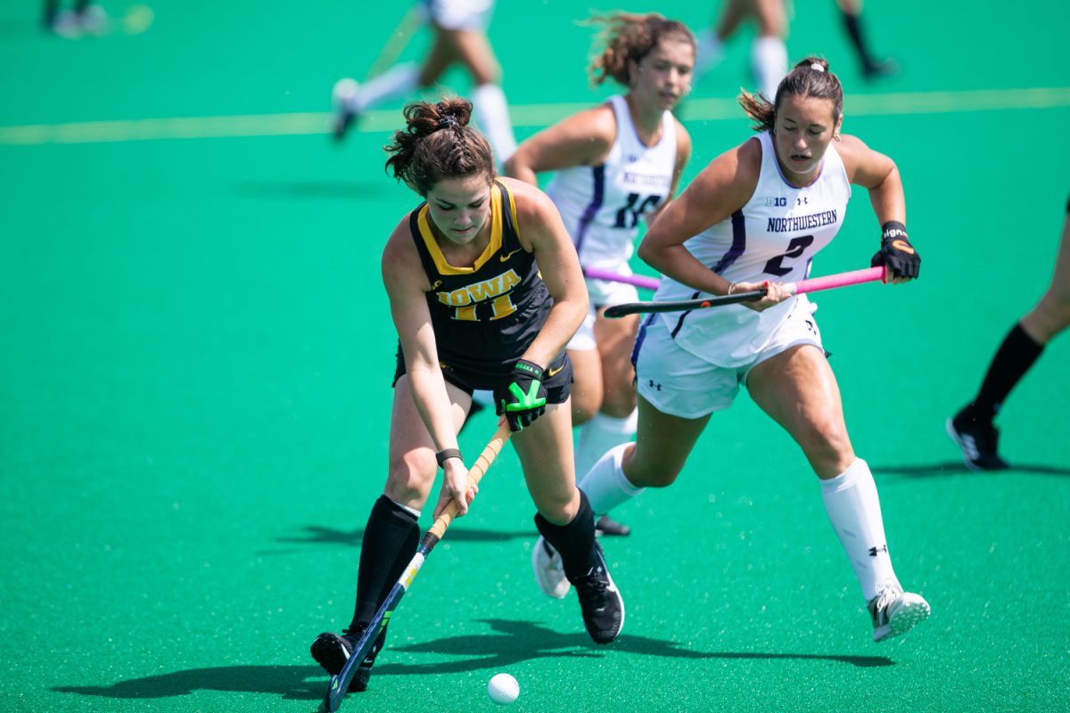 Iowa midfielder Sammy Freeman prepares to hit the ball during a field hockey exhibition match between Iowa and Northwestern at Grant Field in Iowa City on Saturday, Aug. 19, 2023. The Hawkeyes defeated the Wildcats, 3-1.