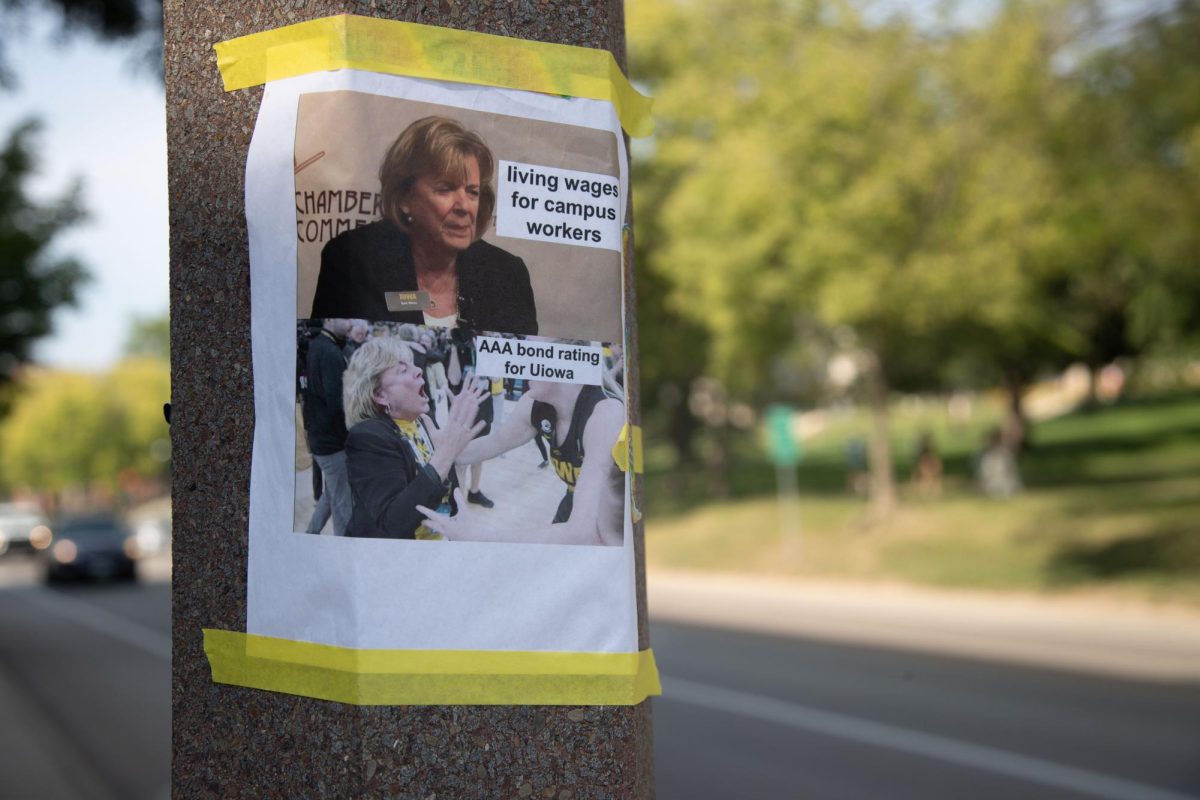 A poster criticizing University of Iowa President Barbara Wilson is taped to a light post infant of the Main Library on Aug. 22, 2023. 
