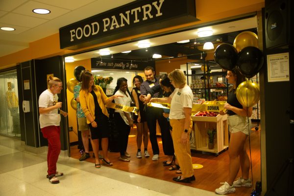 Organizers of the Iowa Memorial Union food pantry cut the ribbon in Iowa City on Thursday Aug. 24, 2023. 