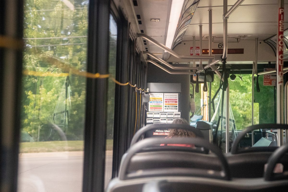 A passenger sits on an Iowa City city bus on Thursday Aug. 24, 2023.