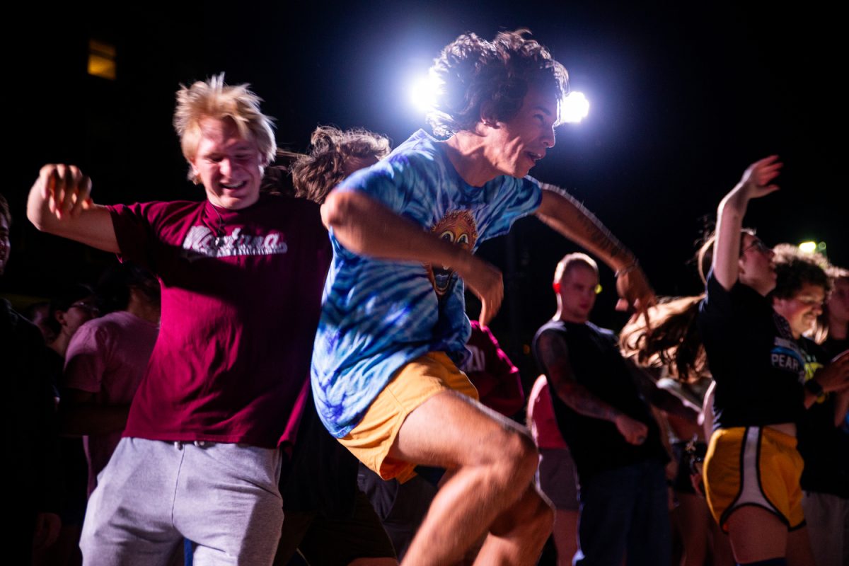 Attendees participate in a mosh pit during Battle of the Bands hosted by Scope Productions at the Iowa Memorial Union River Amphitheater on Wednesday, Aug. 30, 2023. Four different local bands competed throughout the evening and placed after attendees voted.