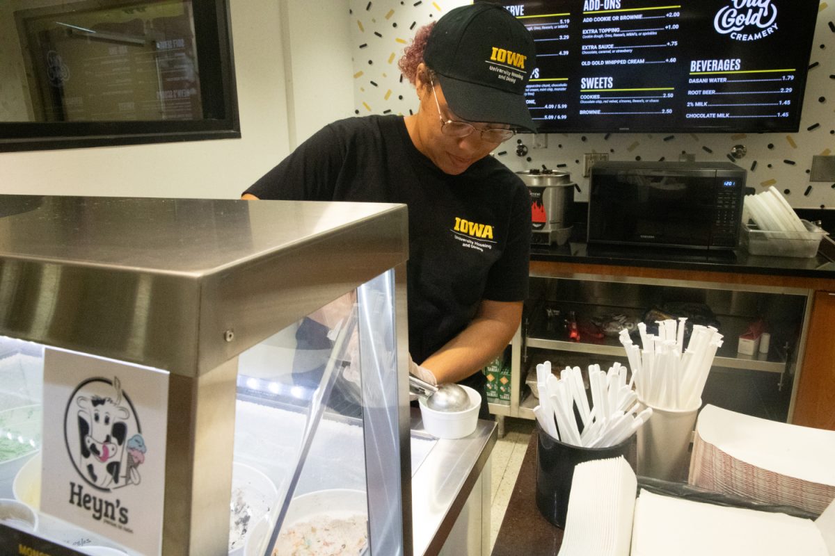 An Old Gold Creamery employee scoops Ice cream in the Iowa Memorial Union on Wednesday, August 16, 2023.