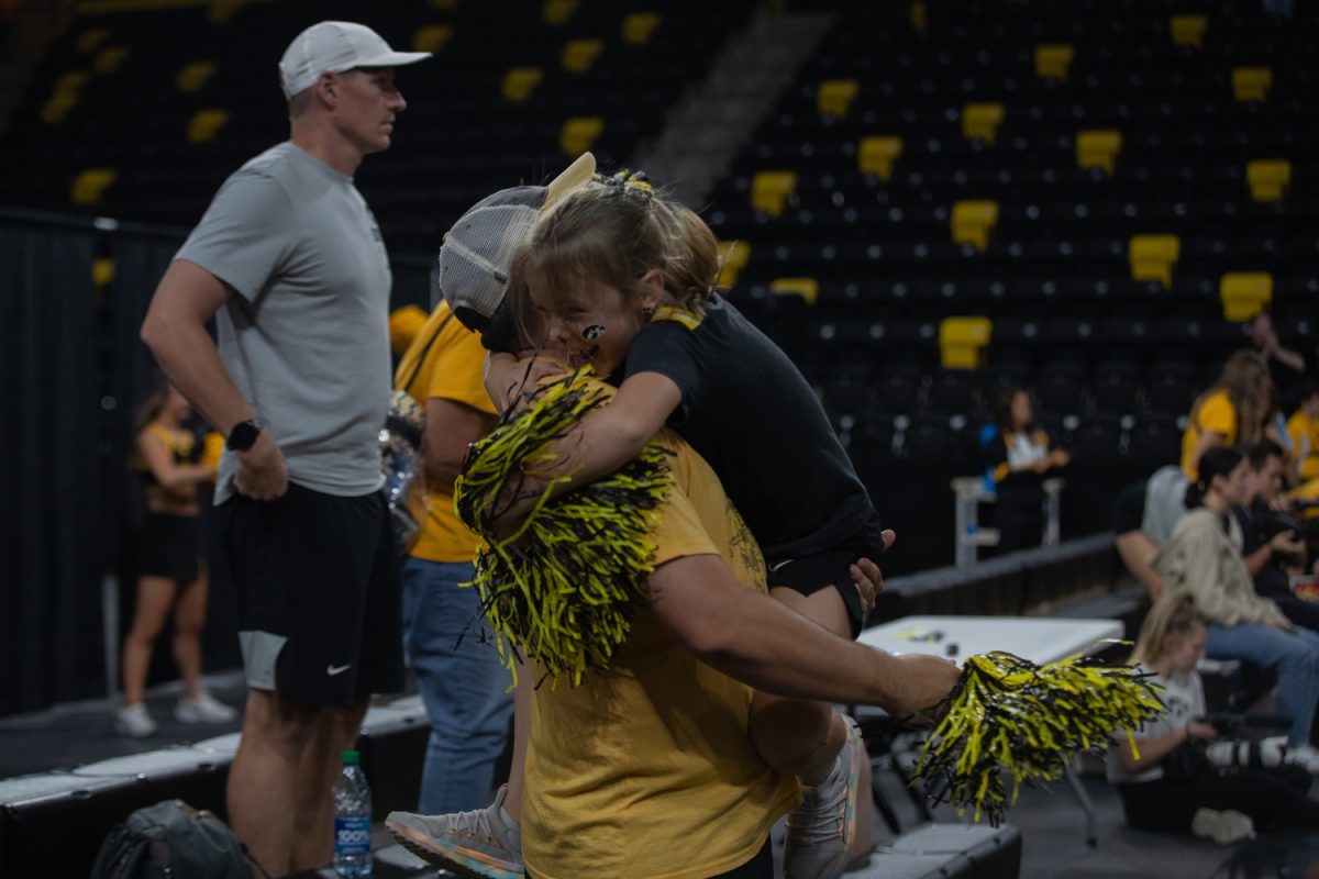Piper and Cody Gengler hug as Iowa wins at a volleyball game between Iowa and Middle Tennessee State on Sep. 1, 2023. The Hawkeyes beat the Blue Raiders, 3-0.