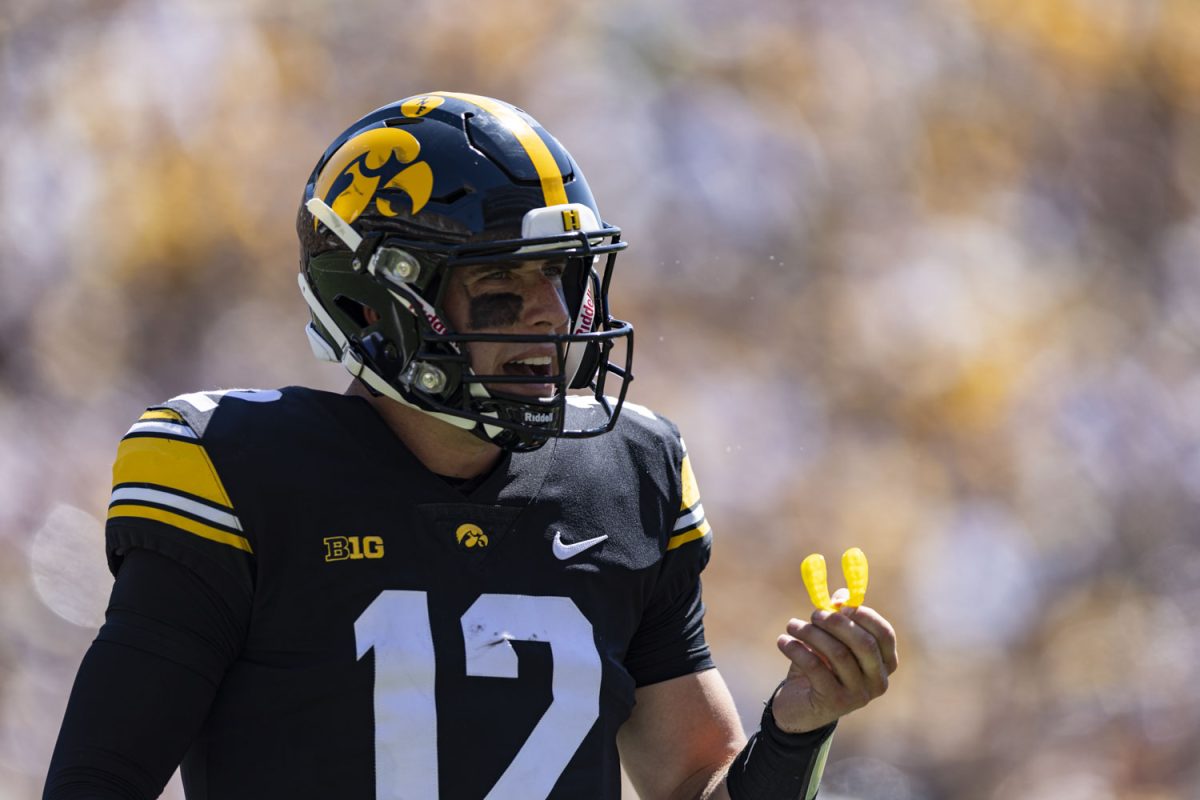 Iowa quarterback Cade McNamara talks to coaches on the sidelines during a football game between No. 25 Iowa and Utah State at Kinnick Stadium on Saturday, Sept. 2, 2023. The Hawkeyes defeated the Aggies, 24-14. 