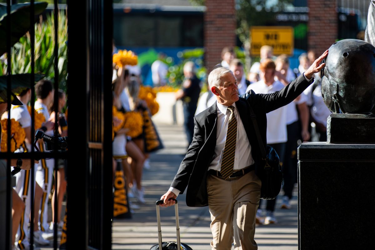 Iowa head coach Kirk Ferentz touches the Kinnick Statue before a football game between No. 25 Iowa and Utah State at Kinnick Stadium, on Saturday, Sept. 2, 2023.  