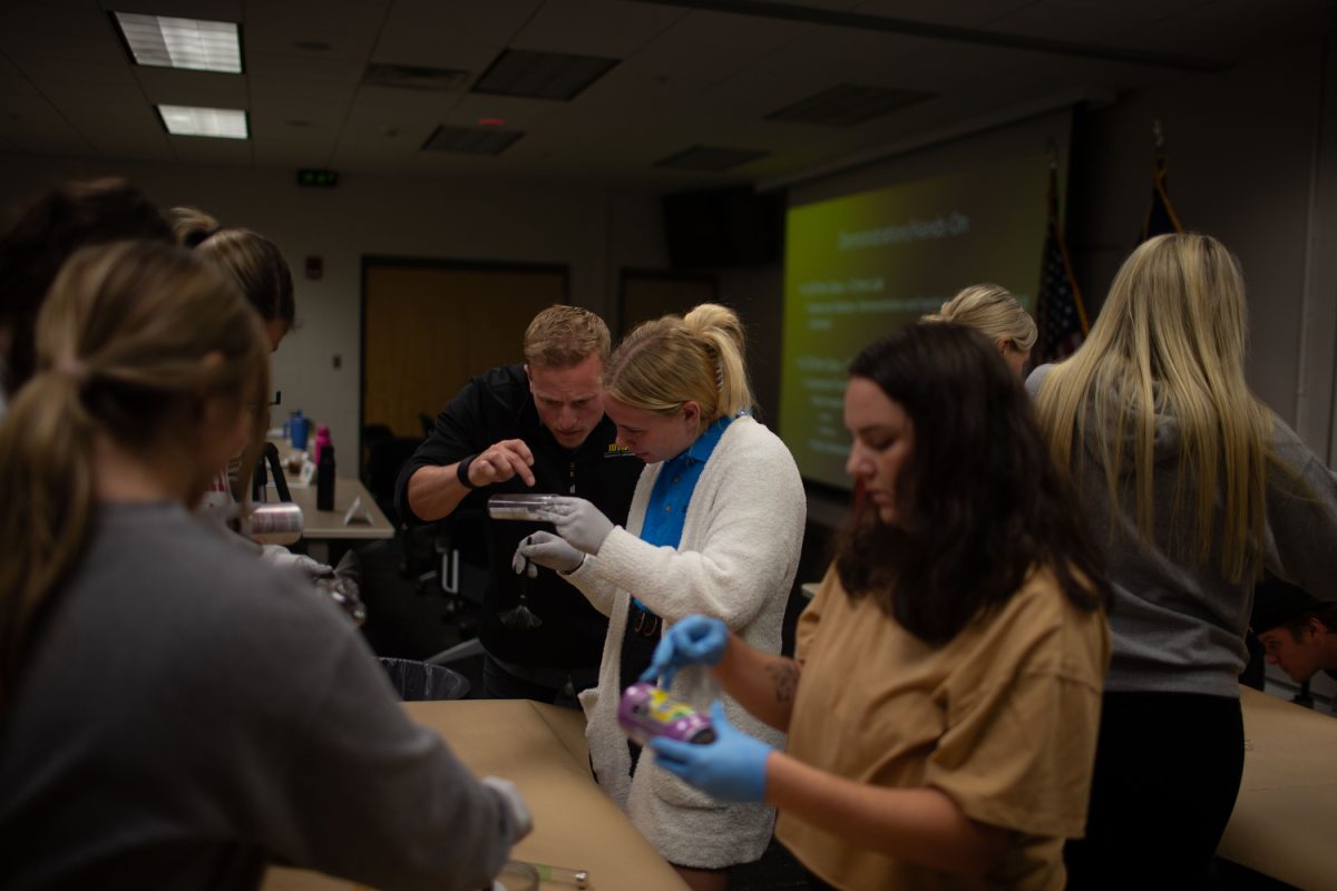 Lieutenant Travis Tyrrell shows students how to dust for fingerprints during a policing practicum course at the UCC in Iowa City on Wednesday, Sept. 6, 2023. 