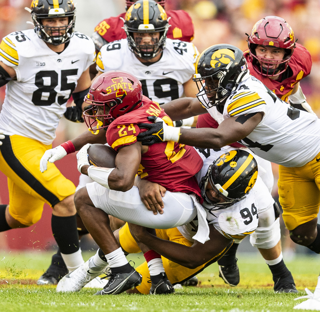 Iowa defensive lineman Yahya Black and linebacker Jay Higgins tackle Iowa State running back Abu Sama during a Cy-Hawk football game between Iowa and Iowa State at Jack Trice Stadium in Ames on Saturday, Sept. 9, 2023. The Hawkeyes defeated the Cyclones, 20-13. Sama rushed for 24 yards.