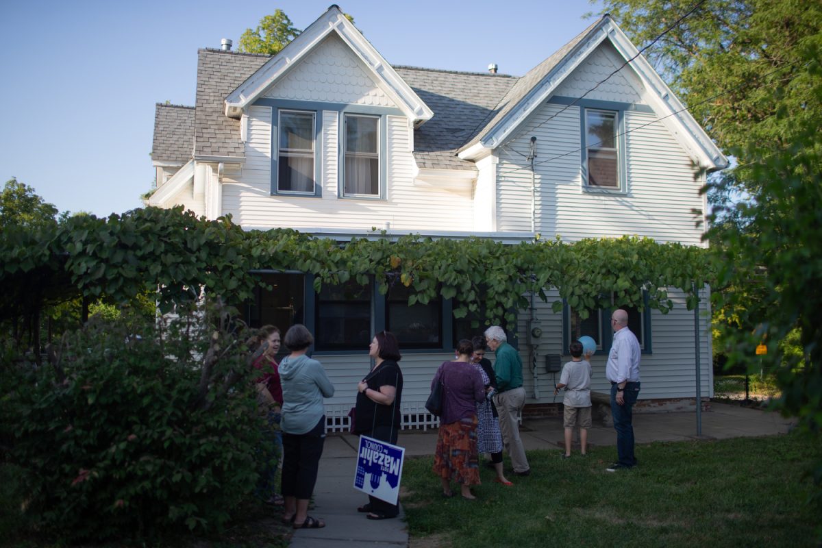 Attendees converse outside during a Immigrant Welcome Network event at 1109 Prairie Du Chien Road Open House, in Iowa City on Wednesday, Sept. 13, 2023. 
