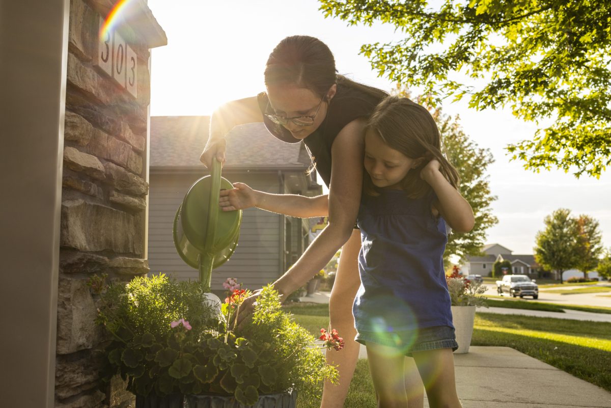 Lexie Olgren, 28, and her daughter, Isabelle, 4, water a plant they bought together at the Olgren family home in Ankeny, Iowa, on Thursday, Sept. 14, 2023. In the fall of 2022, Iowa’s only inpatient eating disorder clinic closed at the University of Iowa Hospitals and Clinics. Olgren was a patient when she was 26 years old, and said the program is crucial to helping those with eating disorders and is upset about its closing. Olgren said she still struggles with disordered eating daily. She said it sucks that her daughters have to watch her go through that. 