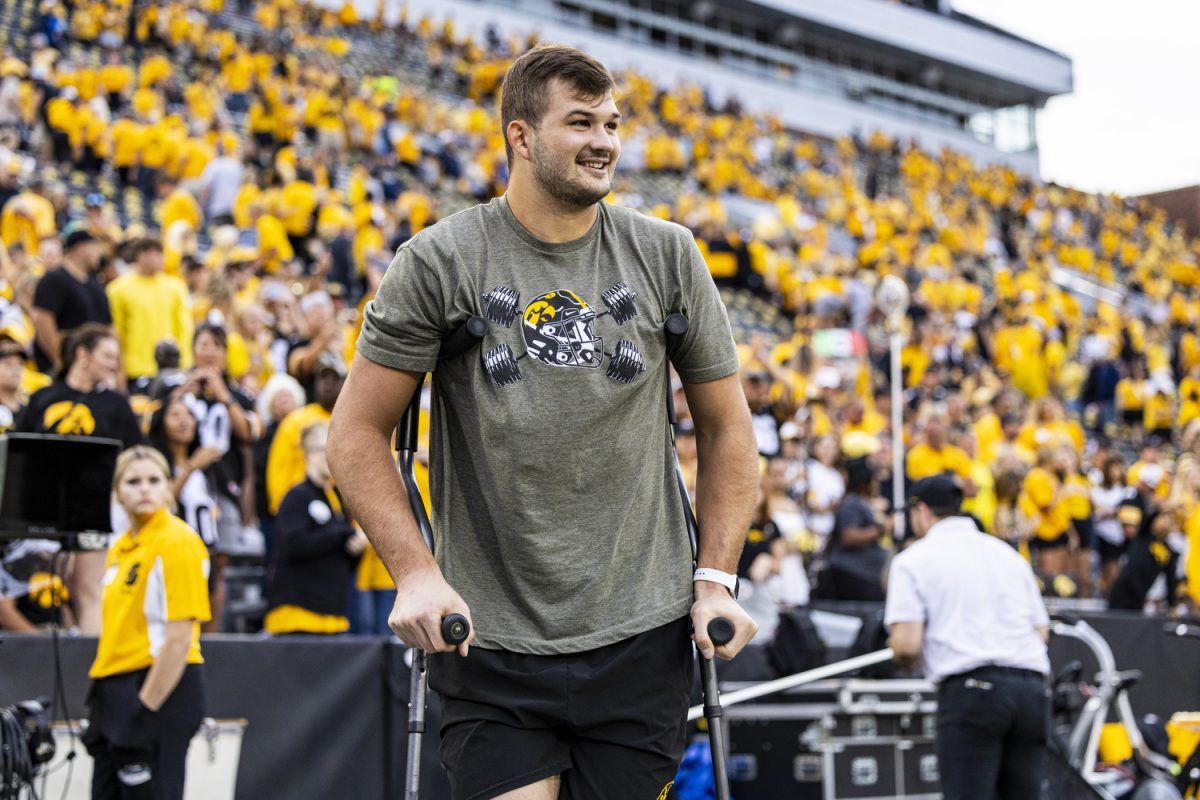 Iowa tight end Luke Lachey watches his teammates celebrate a win during a football game between Iowa and Western Michigan at Kinnick Stadium in Iowa City on Saturday, Sept. 16, 2023. The Hawkeyes defeated the Broncos, 41-10. Lachey sustained an ankle injury in the first quarter of the game.