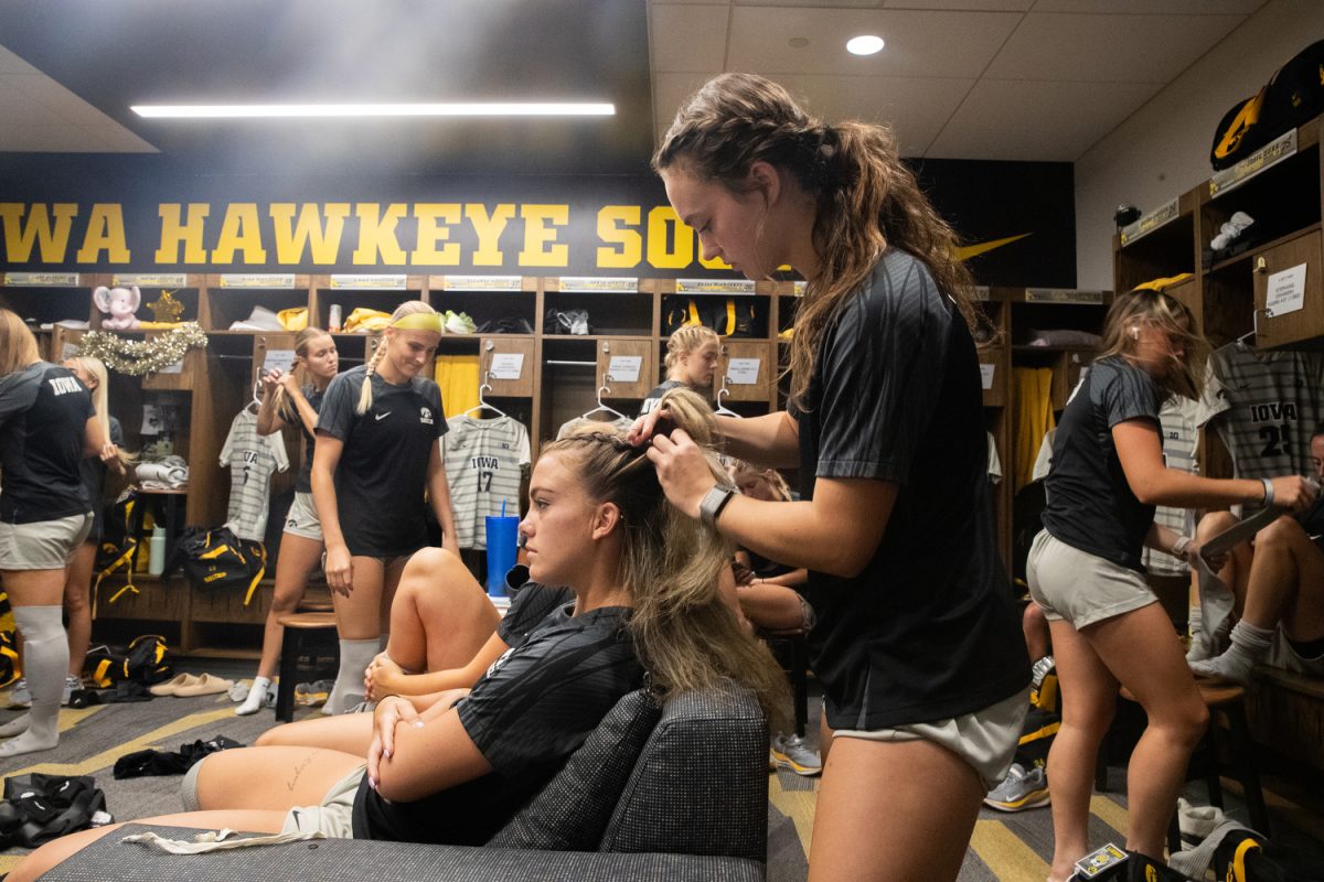Iowa soccer player Morgan Lietz braids teammate Kelli McGroarty’s hair before a soccer game between Iowa and Illinois at the University of Iowa Soccer Complex in Iowa City on Sunday, Sept. 17, 2023. Sunday’s game marked Iowa’s Big 10 home opener.