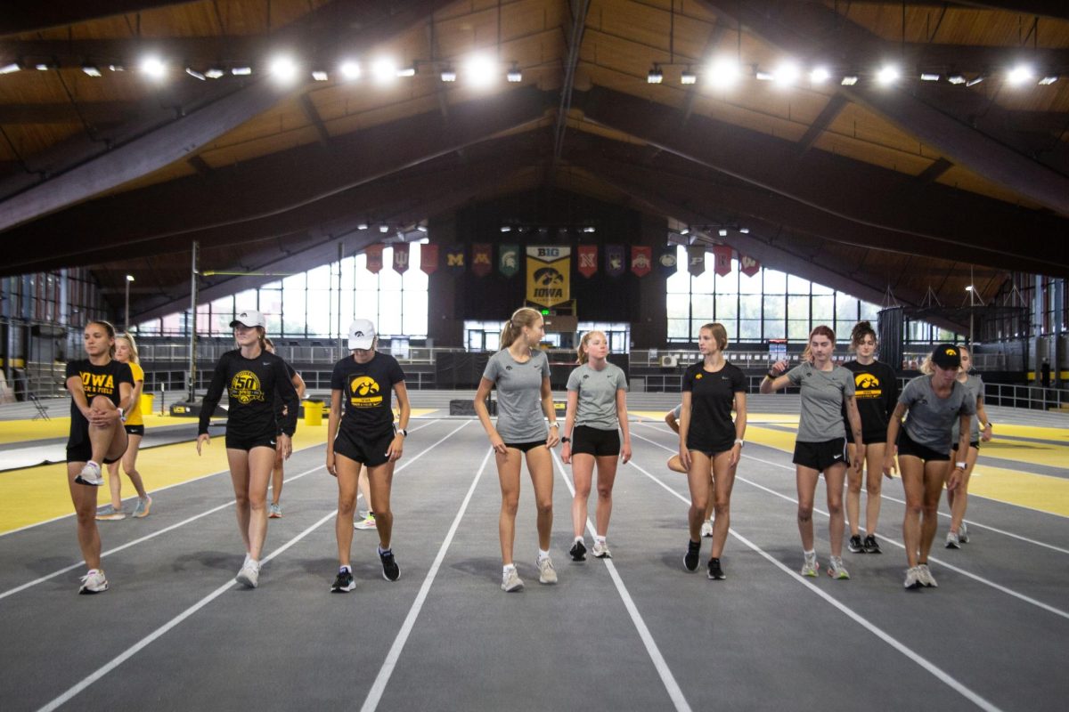 Iowa womens cross country team stretches during a practice at the Hawkeye Indoor Track Facility in Iowa City on Thursday, Sept. 21, 2023.