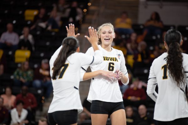 Delaney Sweeney and Kaia Mateo celebrate after a point during the Iowa vs. Minnesota volleyball game at Xtream Arena on Sept. 21, 2023. The Gophers won, 3-2.