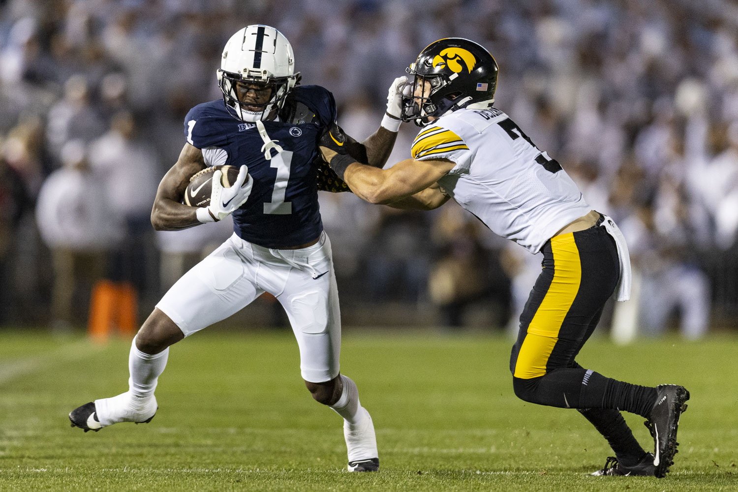 Penn State wide reciever KeAndre Lambert-Smith stiff arms Iowa defensive back Cooper DeJean during a football game between No. 24 Iowa and No. 7 Penn State at Beaver Stadium in State College, Pa., on Saturday, Sept. 23, 2023.