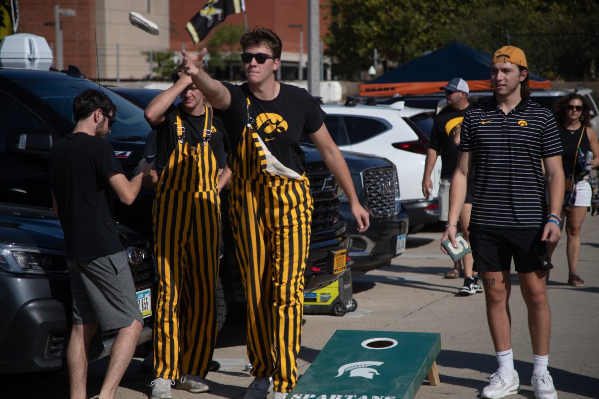 Fans play a game of bags before a football game between Iowa and Michigan State in Iowa City on Saturday Sept. 30, 2023. 