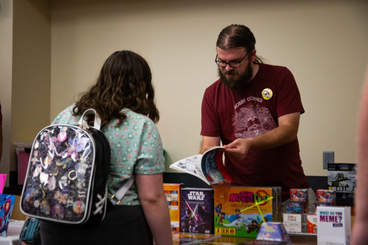 A volunteer interacts with an attendee at a LIbCon in Iowa City on Saturday, Sept. 7, 2023. 