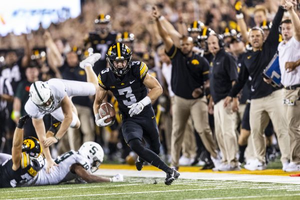 Iowa defensive back Cooper DeJean runs during a punt return to the end zone for a touchdown during a football game between Iowa and Michigan State at Kinnick Stadium in Iowa City on Saturday, Sept. 30, 2023. The Hawkeyes defeated the Spartans, 26-16. (Grace Smith/The Daily Iowan)