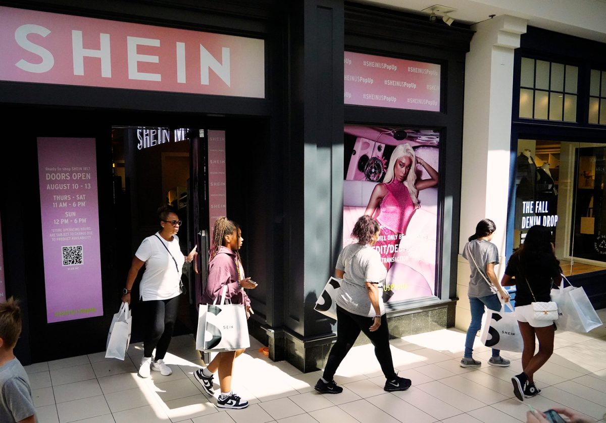 Shoppers exit the Shein pop-up store in Kenwood Mall, Friday, August 11, 2023. The online company, founded in China, is known for low prices. The pop-up runs through Sunday or until they run out of merchandise. The wait time is two to four hours.