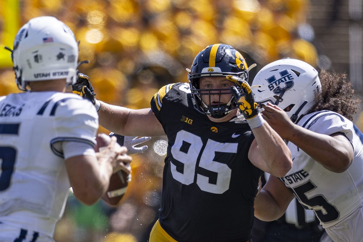 Iowa defensive lineman Aaron Graves rushes Utah State quarterback Cooper Legas during a football game between No. 25 Iowa and Utah State at Kinnick Stadium on Saturday, Sept. 2, 2023. The Hawkeyes defeated the Aggies, 24-14. 
