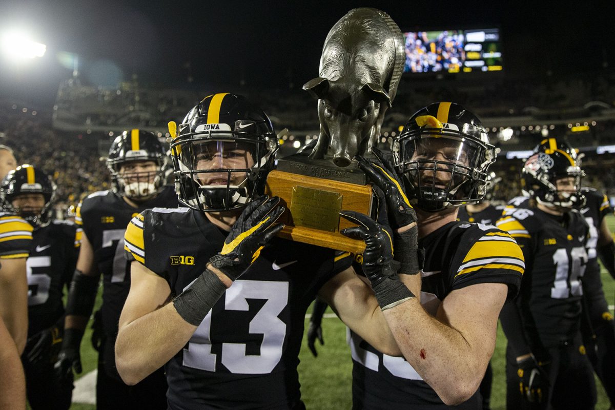 Iowa defensive backs Henry Marchese and Jack Koerner carry the Floyd of Rosedale after a football game between No. 19 Iowa and Minnesota at Kinnick Stadium on Saturday, Nov. 13, 2021. The Hawkeyes defeated Gophers 27-22.