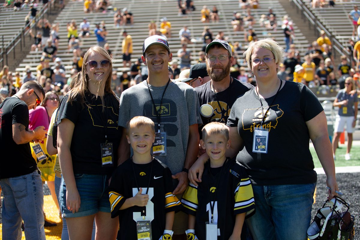 Kid+captain+Max+Schlee+poses+for+a+portrait+with+his+family+during+Kids%E2%80%99+Day+at+Kinnick+in+Iowa+City+on+Saturday%2C+Aug.+12%2C+2023.+