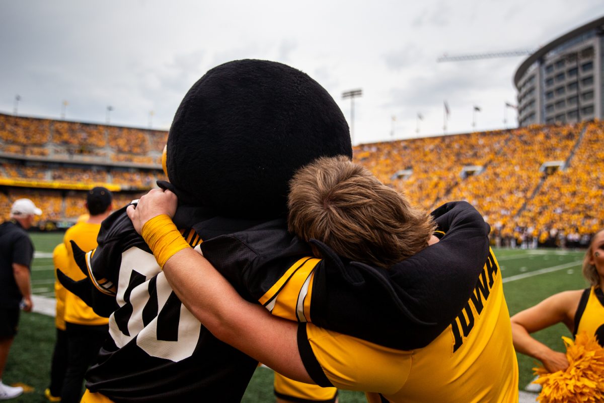 Herky hugs a cheerleader during a football game between Iowa and Western Michigan at Kinnick Stadium in Iowa City on Saturday, Sept. 16, 2023. Herky celebrated his 75th birthday during halftime.