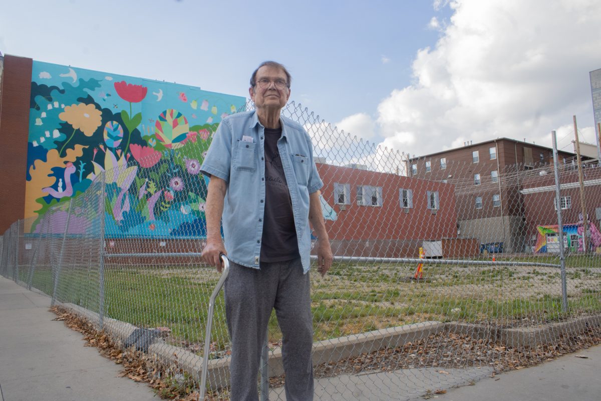 Long-time Iowa City resident Rob Dietrich poses for a portrait at the corner of Washington Street and Linn Street on Wednesday, Sept. 27, 2023. Dietrich is rallying for the open lot across from the Senior Center on Linn Street to be turned into a green space for all ages to appreciate.